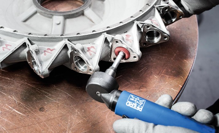 Work on surfaces of a diffusor with POLINOX PNST grinding star and conical tungsten carbide burr with radius end.